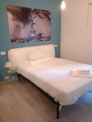 a bed in a bedroom with a painting on the wall at Loft Aurelia 336 in Rome