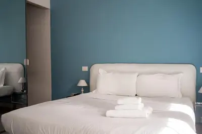 a white bed with towels stacked on top of it at Loft Aurelia 336 in Rome