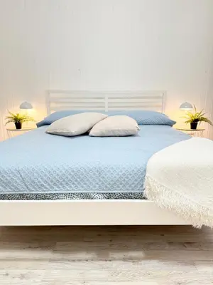 a bedroom with a bed with blue sheets and pillows at VOLUPTA' S HOUSE in Rome MANZONI - COLOSSEO in Rome