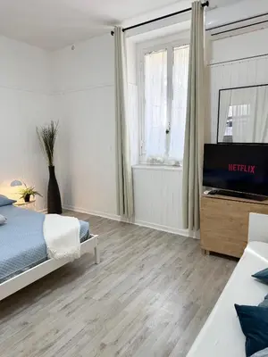 a bedroom with a bed and a television in it at VOLUPTA' S HOUSE in Rome MANZONI - COLOSSEO in Rome