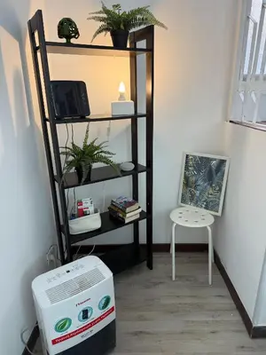 a room with a shelf with a computer and a chair at VOLUPTA' S HOUSE in Rome MANZONI - COLOSSEO in Rome
