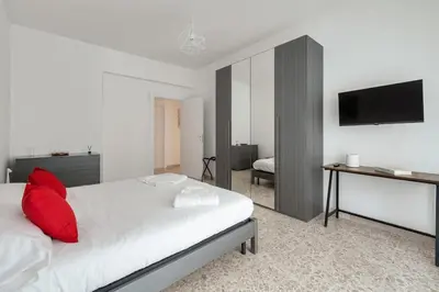a bedroom with a bed with a red pillow on it at Lacasadigió in Rome