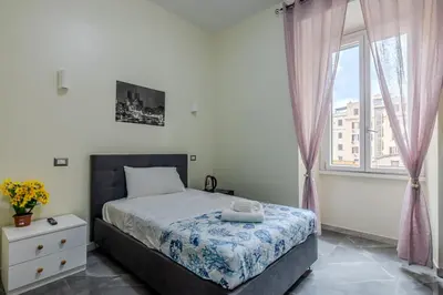 a bedroom with a bed and a window at Viktoria House Rome in Rome