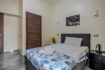 a bedroom with a bed with a towel on it at Viktoria House Rome in Rome