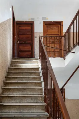 a set of stairs with two wooden doors at Center Suite Garbatella in Rome