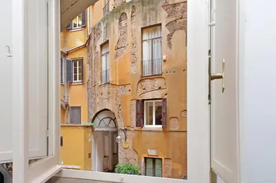 an open door looking out at an old building at Pantheon Apartment Rondanini in Rome