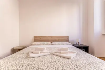 a bedroom with a bed with two pillows on it at SanGiò - Appartamento San Giovanni in Rome