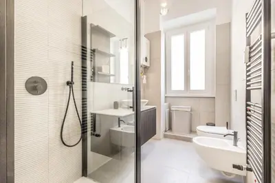 a white bathroom with a sink and a toilet at SanGiò - Appartamento San Giovanni in Rome