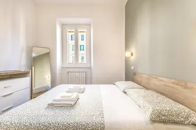 a bedroom with a large bed with towels on it at SanGiò - Appartamento San Giovanni in Rome
