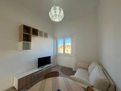 a living room with a couch and a tv at Stylish & Trendy Hub in Rome in Rome