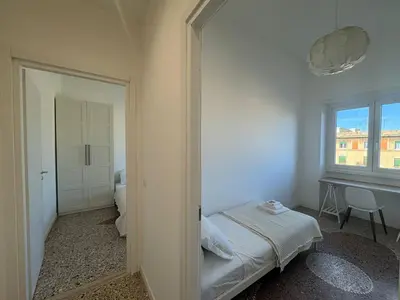 a small bedroom with a bed and a window at Stylish & Trendy Hub in Rome in Rome