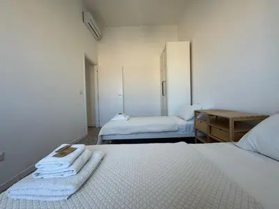a bedroom with two beds with towels on them at Stylish & Trendy Hub in Rome in Rome