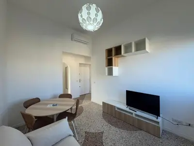 a living room with a couch and a table and a tv at Stylish & Trendy Hub in Rome in Rome