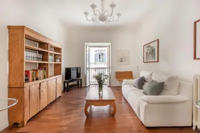a living room with a white couch and a coffee table at Trastevere Penthouse in Rome