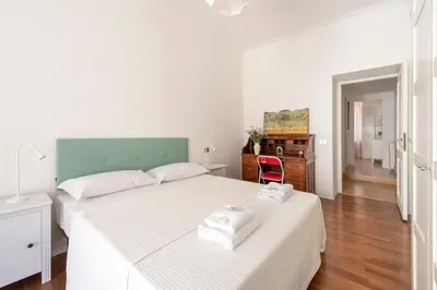 a bedroom with a bed with two towels on it at Trastevere Penthouse in Rome
