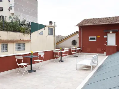 a patio with tables and chairs on a building at BNB Ostiense in Rome