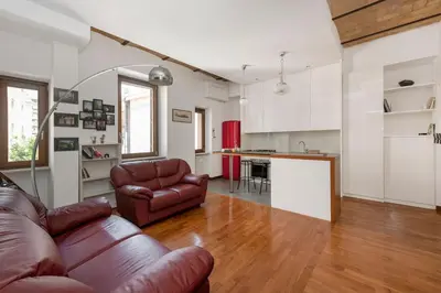 a living room with a couch and a kitchen at Hip Pad in Garbatella in Rome