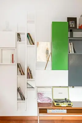 a room with a table and shelves with books at Hip Pad in Garbatella in Rome