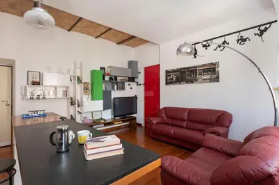 a living room with a red couch and a table at Hip Pad in Garbatella in Rome