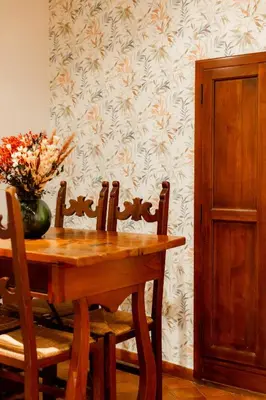 a dining room table with a vase of flowers on it at ZENO 13 Paradiso - Casa Verde in Rome