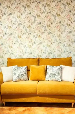 a yellow couch with three pillows in a living room at ZENO 13 Paradiso - Casa Verde in Rome
