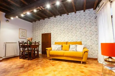 a living room with a yellow couch and a table at ZENO 13 Paradiso - Casa Verde in Rome