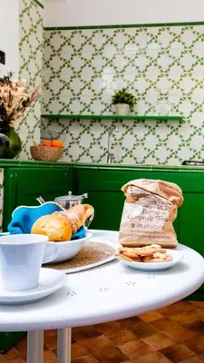 a table with two plates of food and a bag of bread at ZENO 13 Paradiso - Casa Verde in Rome