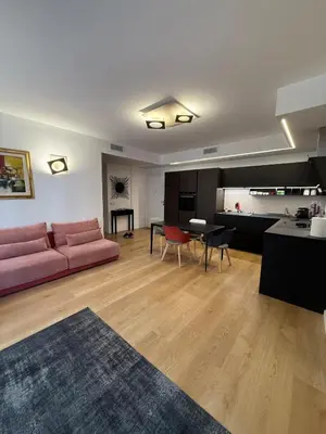 a living room with a pink couch and a table at Appartamento in Rome