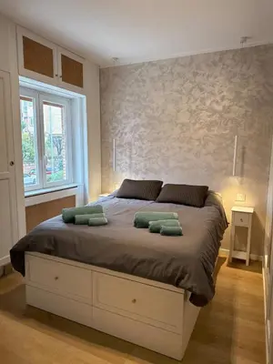 a bedroom with a bed with two pillows on it at Appartamento in Rome