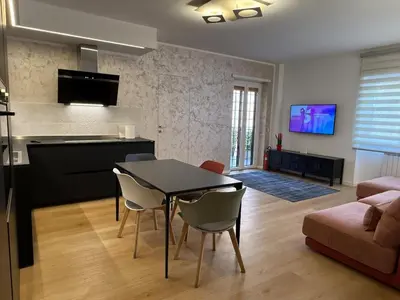 a kitchen and a living room with a table and chairs at Appartamento in Rome