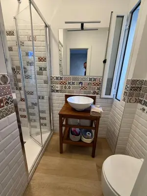 a bathroom with a sink and a shower and a toilet at Appartamento in Rome