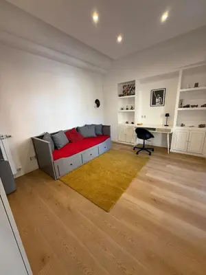 a living room with a bed and a desk at Appartamento in Rome