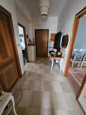 a hallway with a wooden door and a table at CS Banco Apartment in Rome