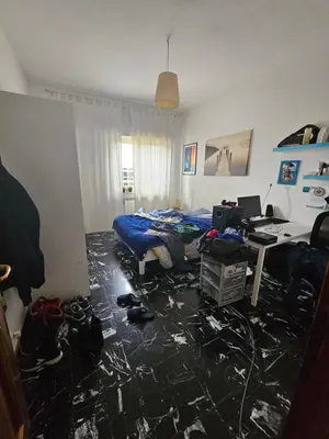 a bedroom with a bed and a desk with a computer at CS Banco Apartment in Rome