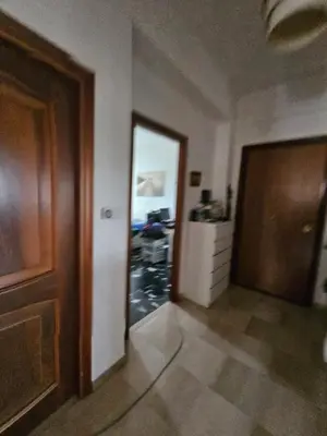 a hallway with a door and a room with a motorcycle at CS Banco Apartment in Rome
