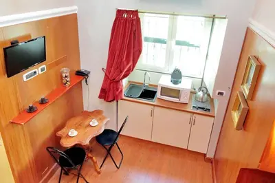 a small kitchen with a table and a microwave at Colosseum Studio in Rome