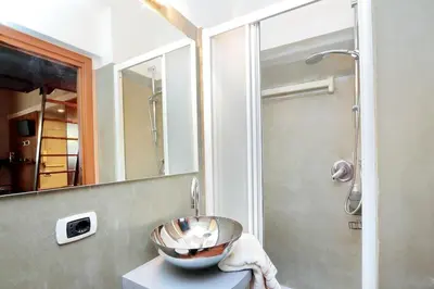 a bowl on a counter in a bathroom with a shower at Colosseum Studio in Rome