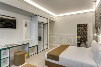 a hotel room with a bed and a desk at Relais Marco Polo in Rome