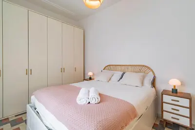 a bedroom with a bed with two towels on it at Domus Ana- Modern Elegance, steps away from the colosseum and the historic center in Rome