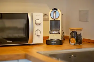 a kitchen counter with a microwave and a toaster oven at Domus Ana- Modern Elegance, steps away from the colosseum and the historic center in Rome