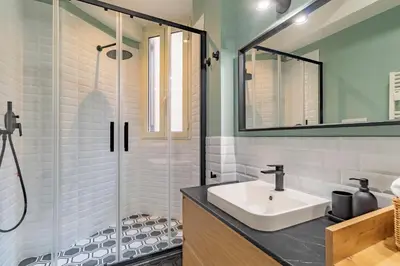 a bathroom with a sink and a shower at Domus Ana- Modern Elegance, steps away from the colosseum and the historic center in Rome