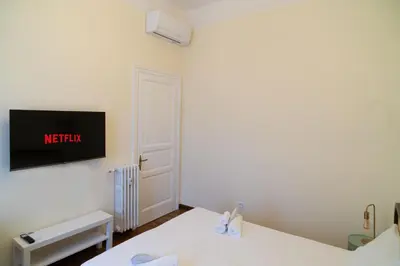 a room with two beds and a tv on the wall at Ampio appartamento A 500 mt dai musei Vaticani in Rome