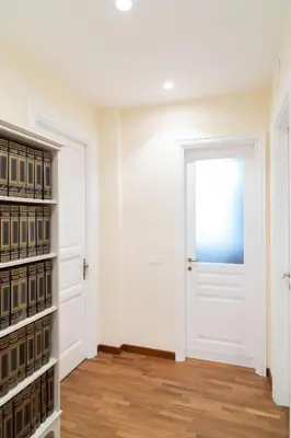 an empty room with a white door and bookshelves at Ampio appartamento A 500 mt dai musei Vaticani in Rome