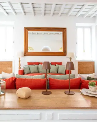 a living room with a red couch and a mirror at Luxury House Lungaretta - ZENO 50 in Rome