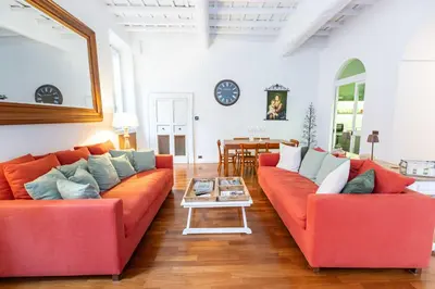 a living room with two red couches and a table at Luxury House Lungaretta - ZENO 50 in Rome