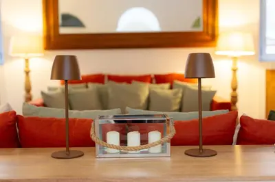 a table with two lamps and a couch at Luxury House Lungaretta - ZENO 50 in Rome