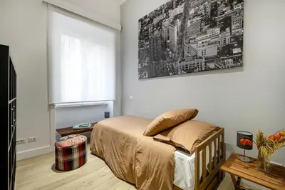 a bedroom with a bed and a painting on the wall at Bordeaux luxury apartment Rome in Rome