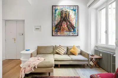 a living room with a couch and a painting on the wall at Bordeaux luxury apartment Rome in Rome