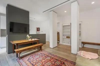 a living room with a table and a tv at Bordeaux luxury apartment Rome in Rome