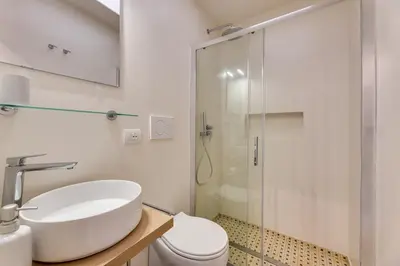 a bathroom with a toilet and a sink and a shower at New home trastevere in Rome